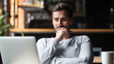 Man reflecting on Northwestern Mutual’s Weekly Market Commentary.