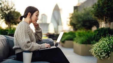 Woman reading Northwestern Mutual’s Weekly Market Commentary.