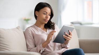 Woman reading news on a tablet.